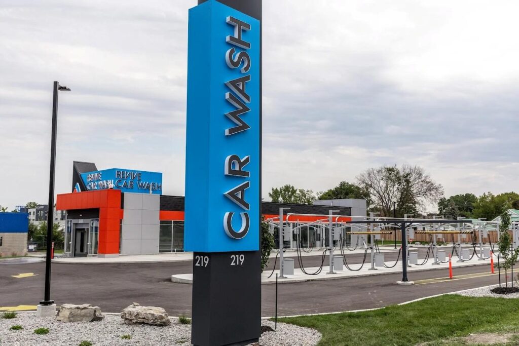 A sign advertising a car wash is displayed in front of a building, highlighting the service offered at this location.